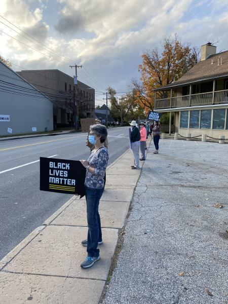 People holding Black Lives Matter poster