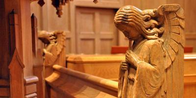 Photo of angel carved in wooden pews in chapel at Bryn Mawr Presbyterian Church